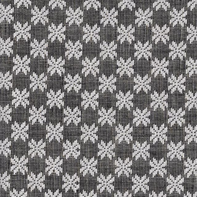 Charcoal woven fabric with repeating ivory eight-point stars in a compact geometric pattern