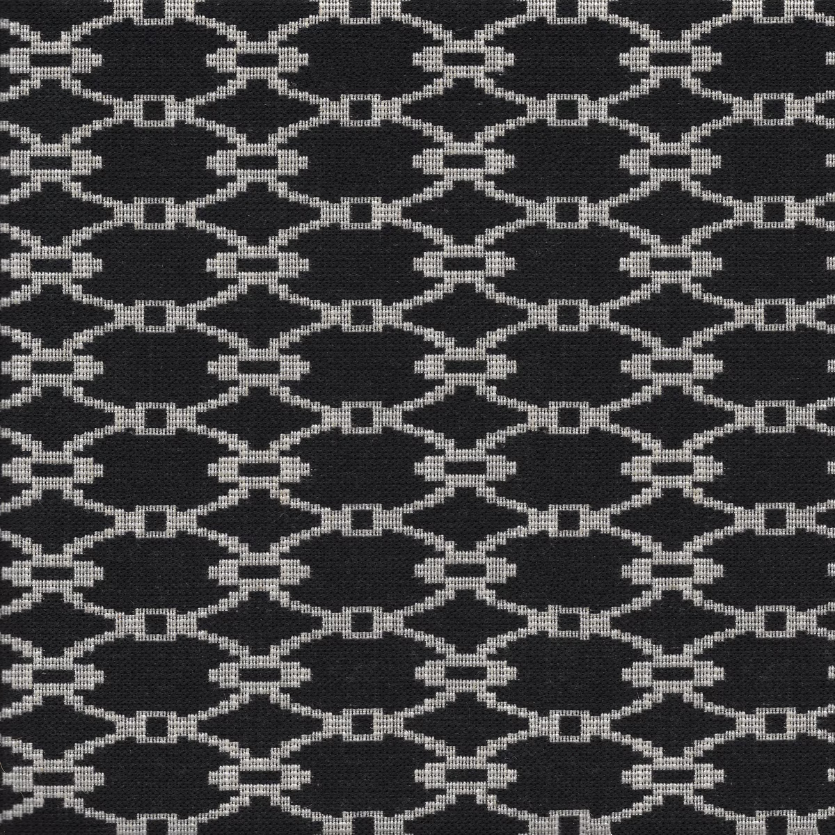Charcoal woven swatch with repeating ivory interlocking oval lattice