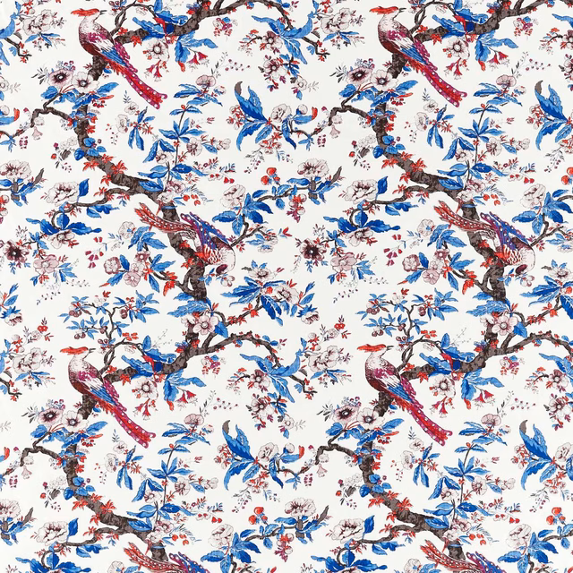 Cobalt blue birds and flowering branches across a cream chintz fabric