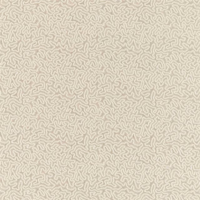 Warm coral-stone fabric with a dense ivory maze pattern and softly textured woven surface