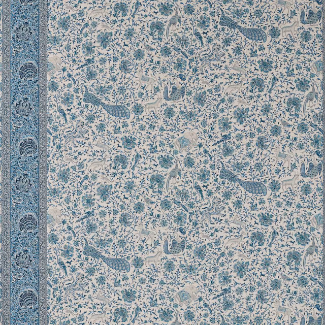 Mazarine blue peacocks and curling foliage on an ivory wallpaper ground