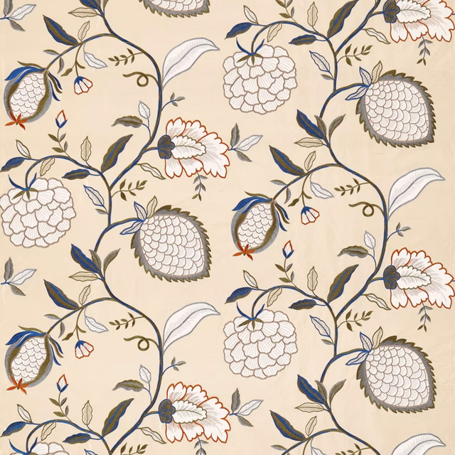 Warm cream textile with navy pomegranates, rust flowers and scrolling dark stems