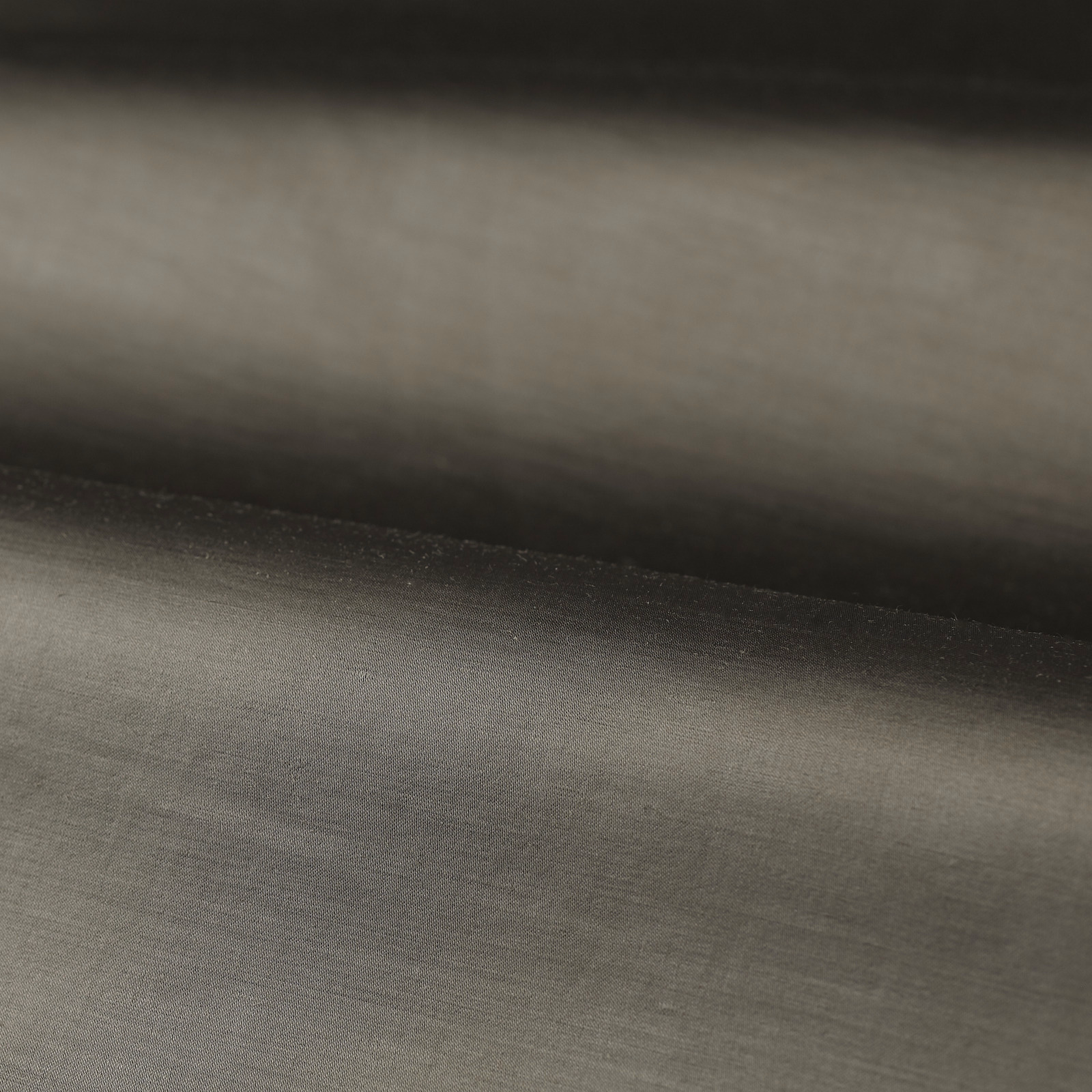 Deep anthracite plain weave with a soft grey sheen across folded cloth
