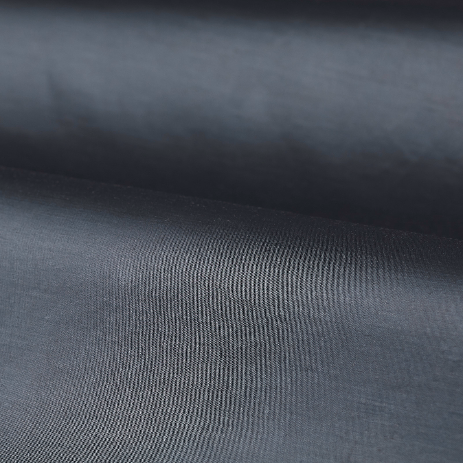 Muted blue-grey plain fabric with a fine, softly textured woven surface