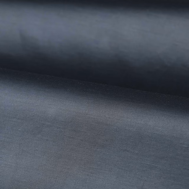 Muted blue-grey plain fabric with a fine, softly textured woven surface