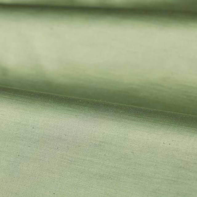 Pale olive plain fabric with fine horizontal weave and soft folded sheen