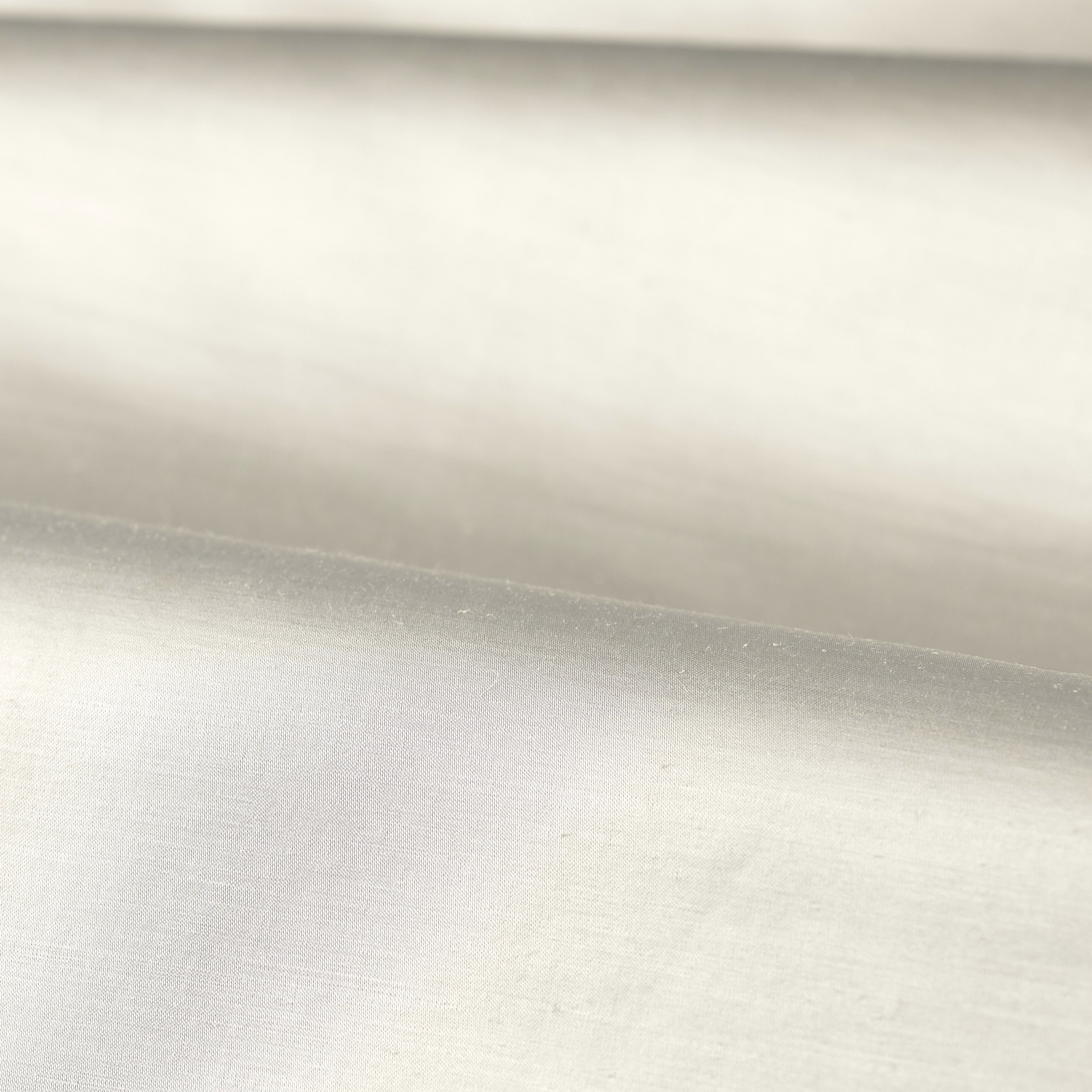 Folded platinum-white plain weave showing a fine, softly silvery surface