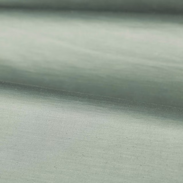 Misted blue-green plain weave with soft grey shading and a folded edge