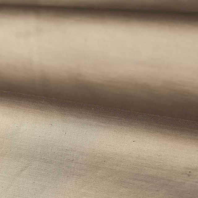 Warm stone-taupe plain woven fabric showing subtle horizontal tonal shading