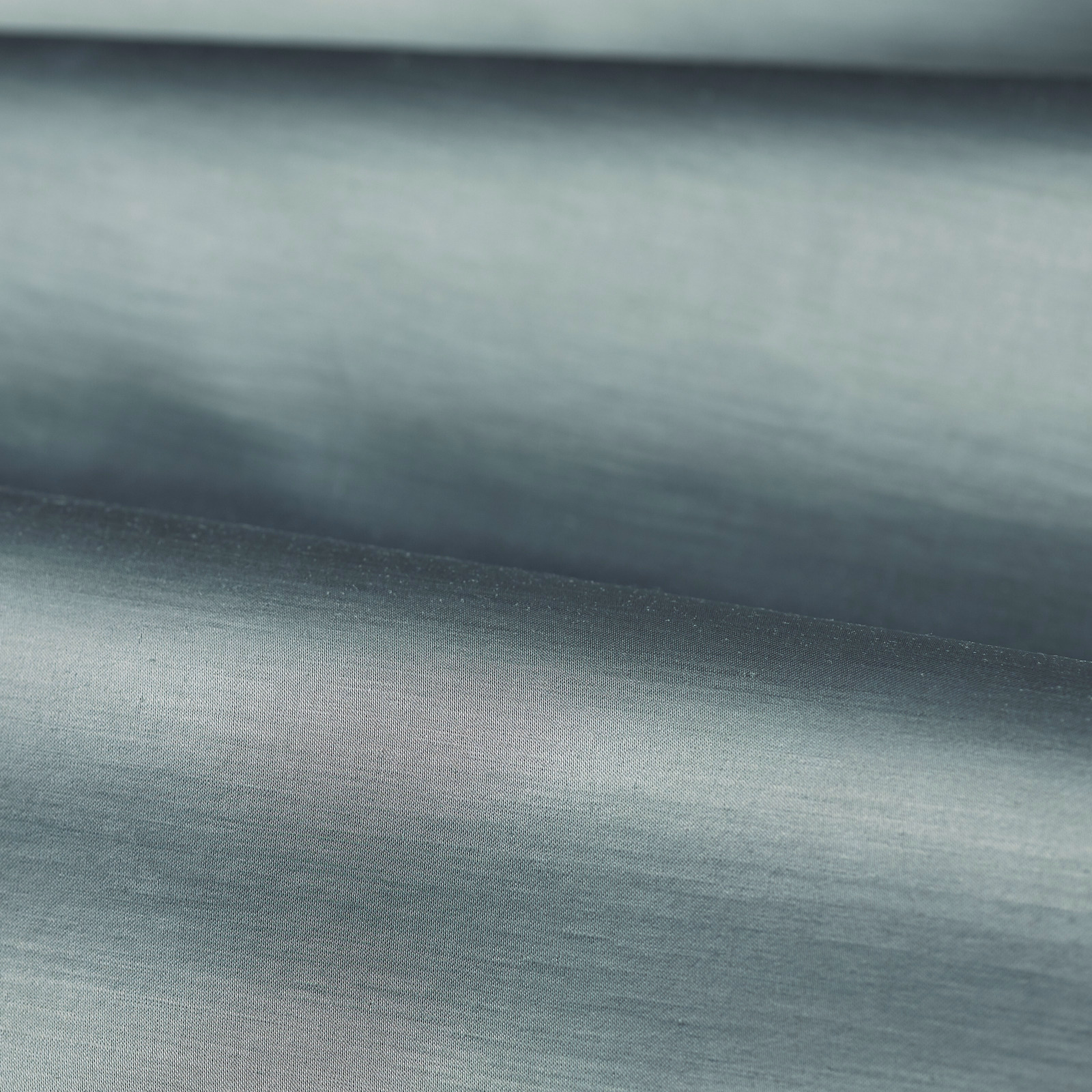 Cool Wedgwood blue-grey plain weave with soft horizontal grain and gentle folded sheen