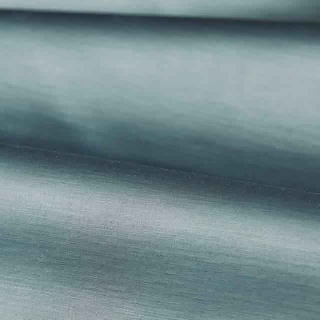 Cool Wedgwood blue-grey plain weave with soft horizontal grain and gentle folded sheen