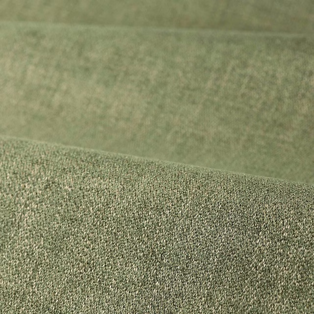 Muted sage-green stone fabric with dense finely pebbled woven texture
