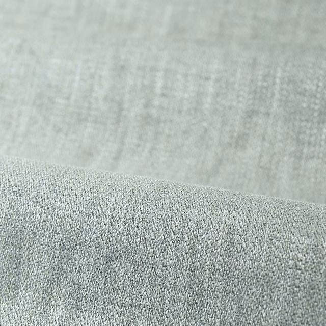 Pale sage grey-green plain upholstery fabric with a dense pebbled weave