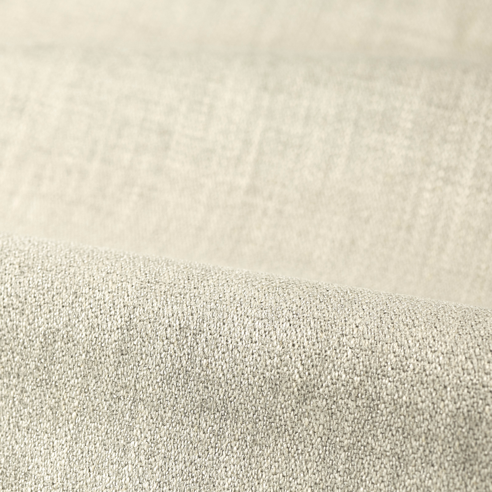 Pale mist-grey plain upholstery fabric showing a dense, softly pebbled woven texture