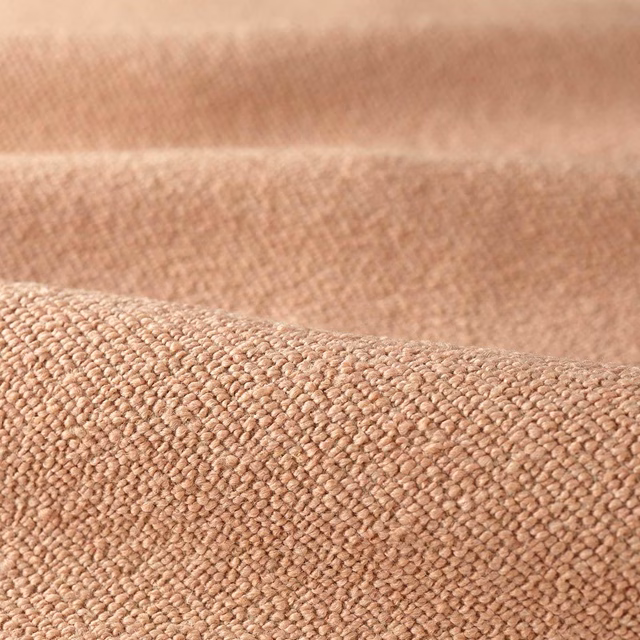 Warm blush-pink boucle with a dense, softly pebbled woven surface