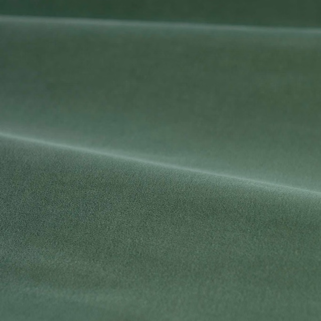 Muted eau de nil green velvet showing directional pile and soft diagonal sheen