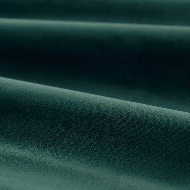 Deep emerald green plain velvet folded to show soft sheen and dark tonal shading