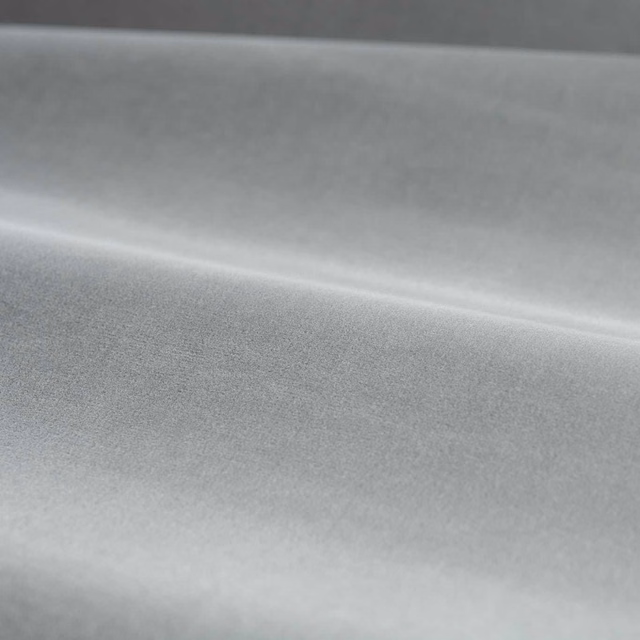 Cool silver-grey velvet showing directional pile and softly light-catching folds