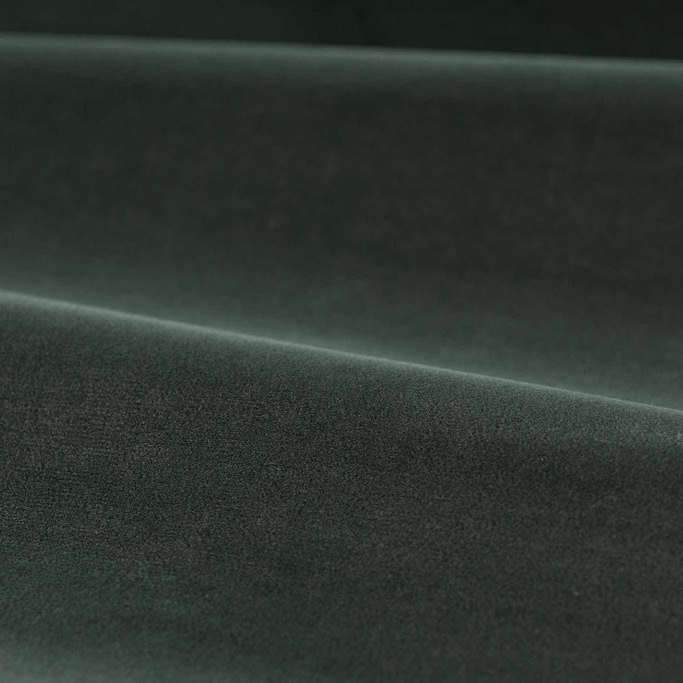 Deep green slate velvet with softly brushed pile catching light across folded cloth