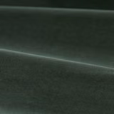 Deep green slate velvet with softly brushed pile catching light across folded cloth