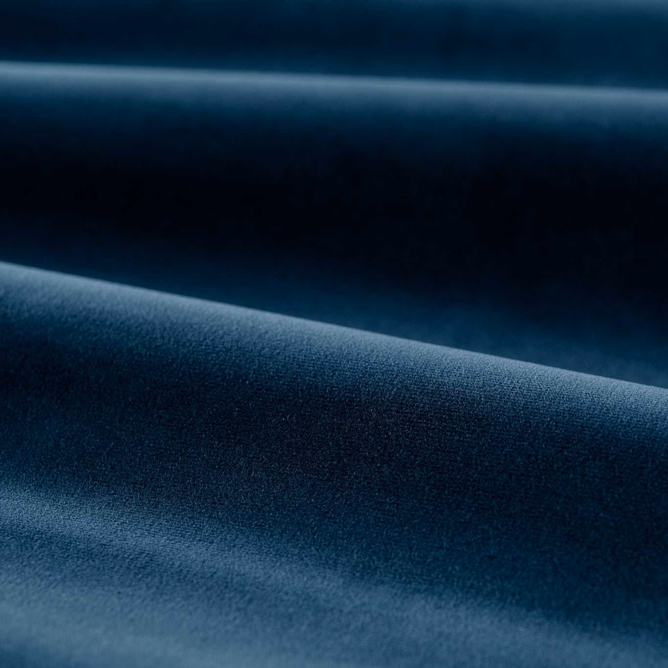 Deep mazarine blue velvet swatch showing a smooth plain pile and soft folded sheen