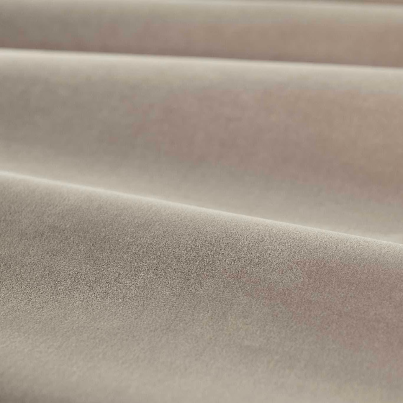 Close-up of muted mink taupe velvet with soft pile and folded shading