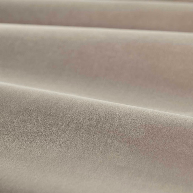 Close-up of muted mink taupe velvet with soft pile and folded shading