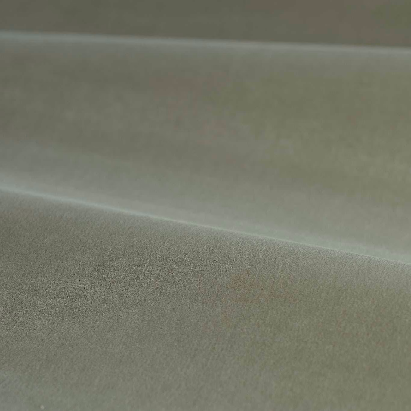 Muted grey-green velvet with soft pile and gentle highlights across folded fabric