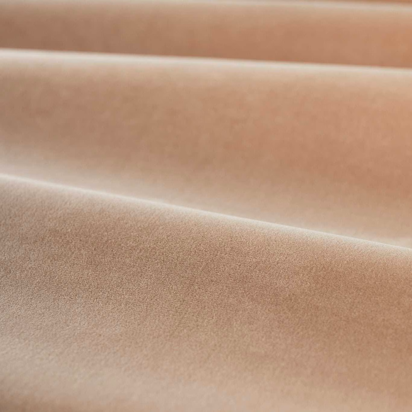 Warm rose-pink plain velvet showing plush directional pile and softly shaded folds