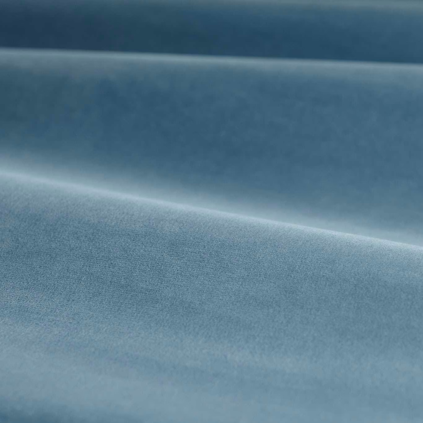 Muted Wedgwood blue velvet with soft directional sheen and folded plush surface