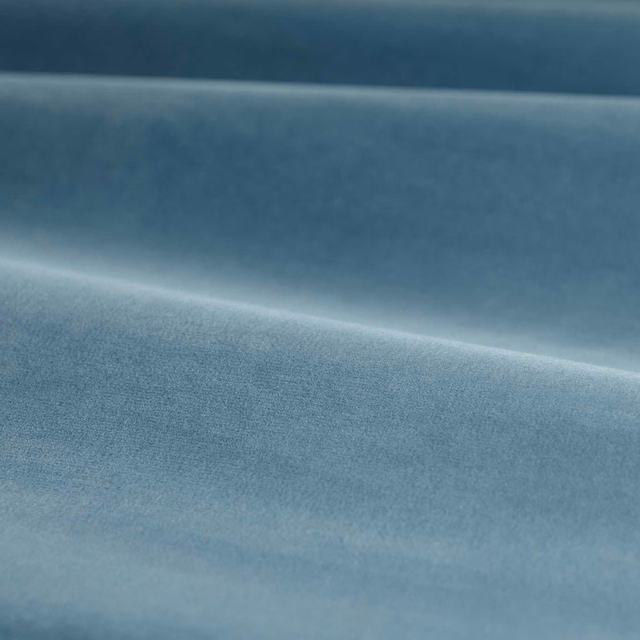 Muted Wedgwood blue velvet with soft directional sheen and folded plush surface