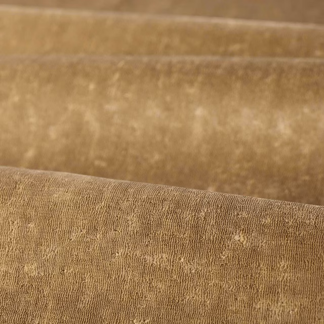 Warm antelope taupe woven upholstery fabric with fine ridges and pale flecks