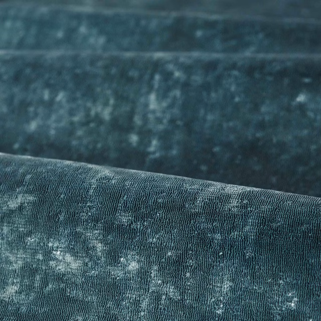 Deep smoky azure blue fabric with fine vertical ribs and mottled pale-blue highlights