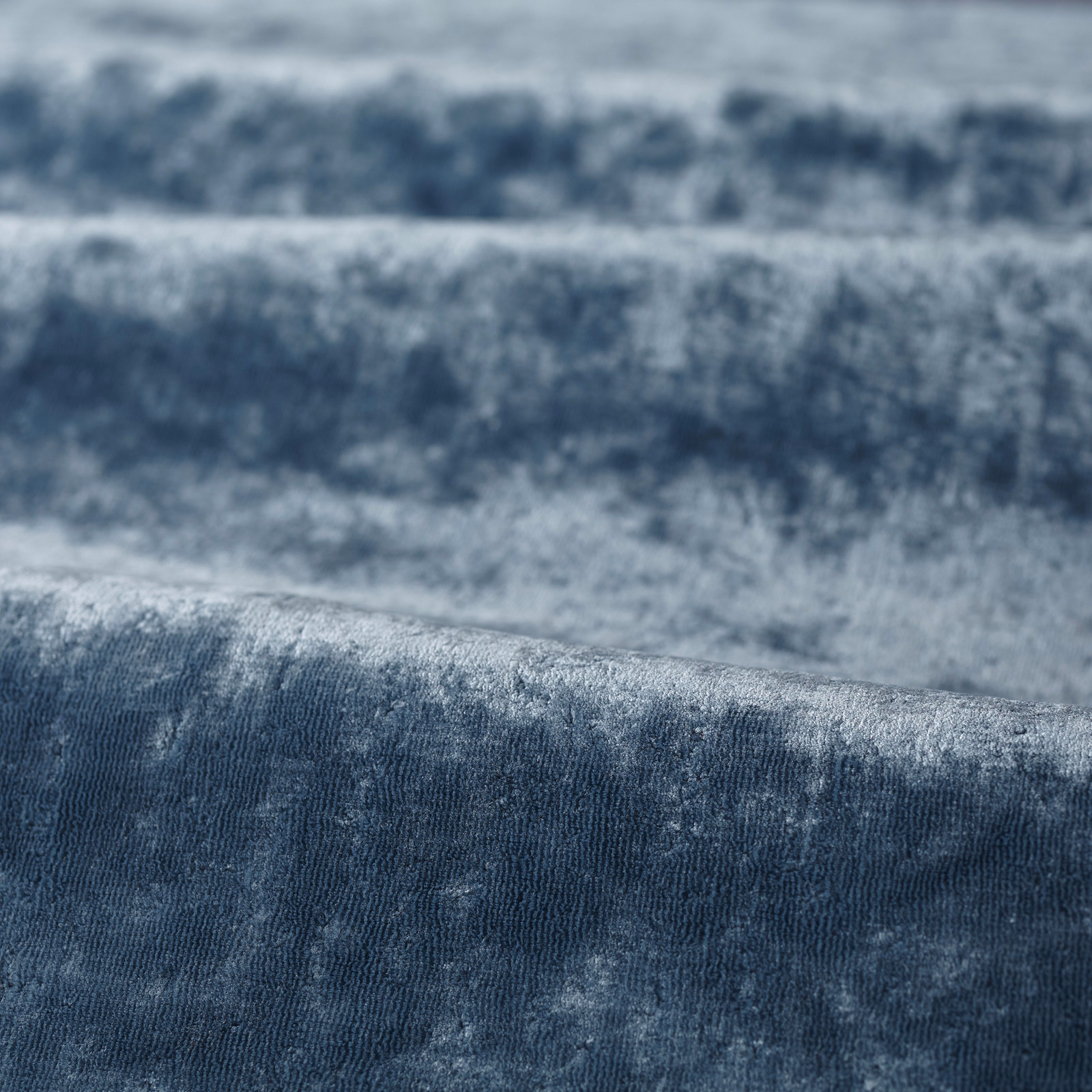 Mottled blue-grey pile with pale steel highlights and deep blue shading