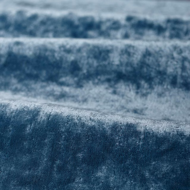 Mottled blue-grey pile with pale steel highlights and deep blue shading