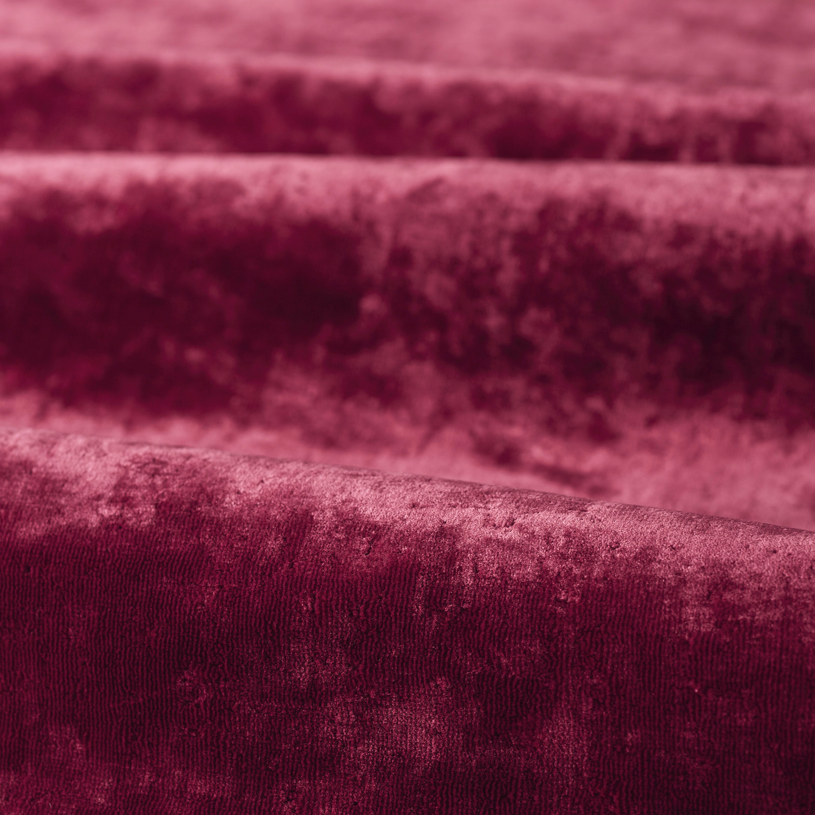 Deep burgundy plain velvet-like fabric showing softly mottled pile and darker brushed bands