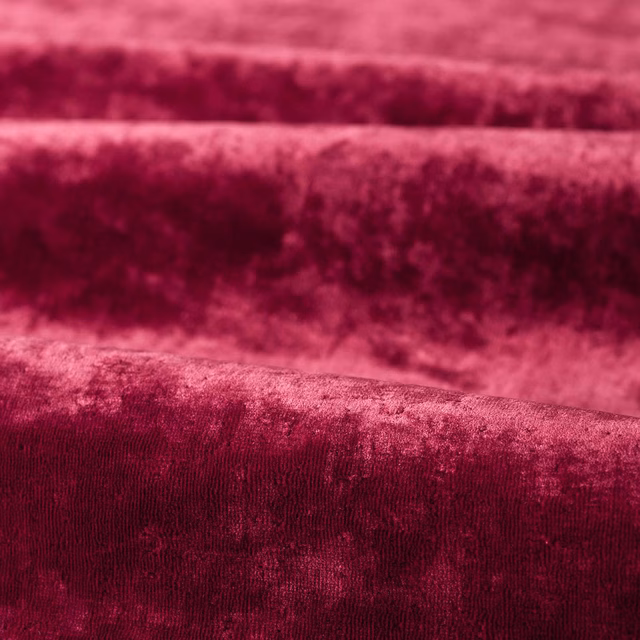 Deep burgundy plain velvet-like fabric showing softly mottled pile and darker brushed bands