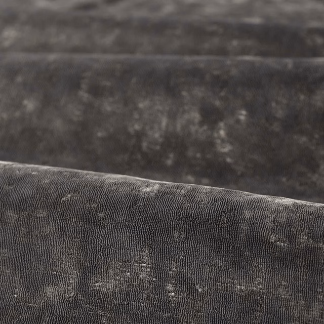 Close-up of charcoal ribbed fabric with pale grey mottled flecks