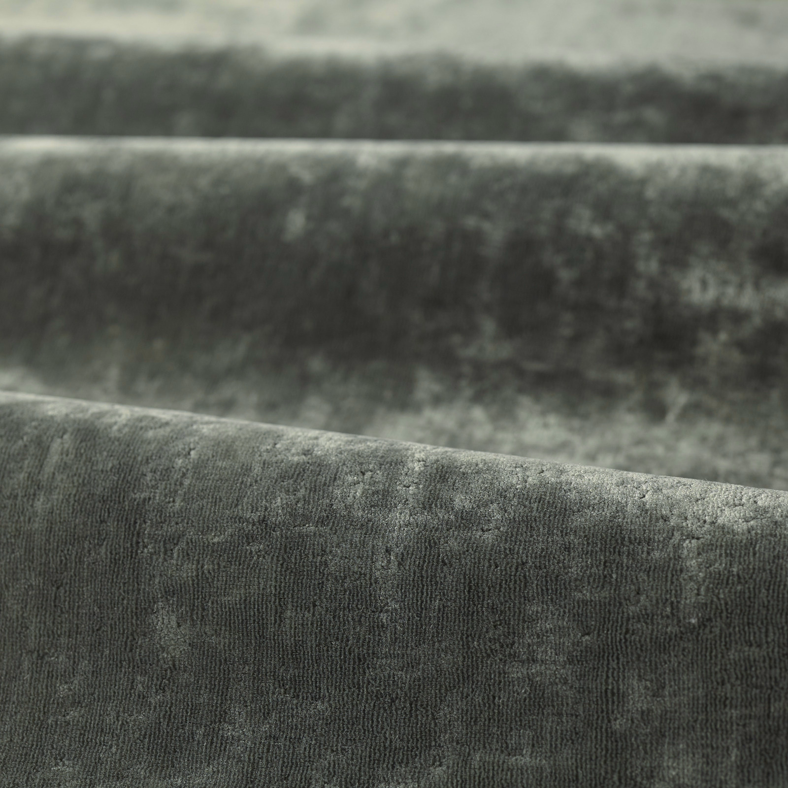 Deep green-slate velvet pile with cloudy shading and fine vertical texture