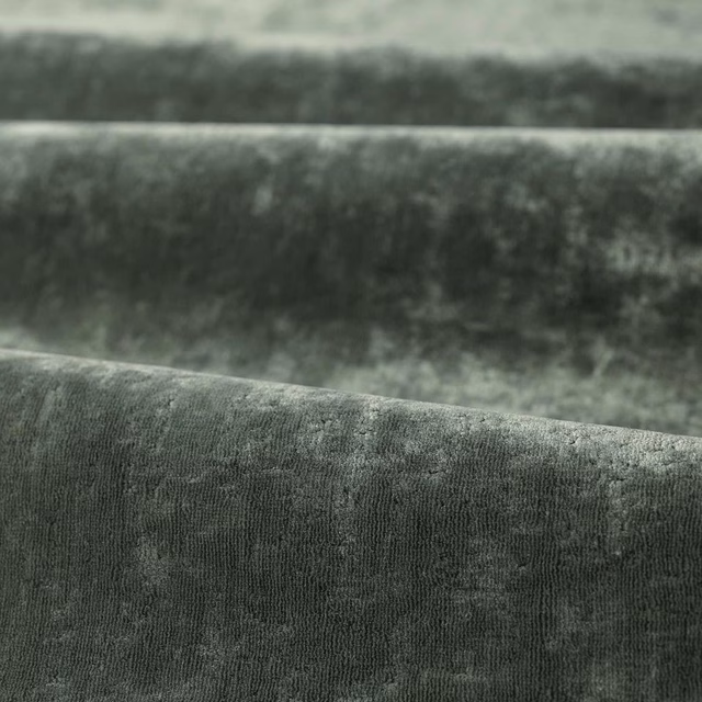 Deep green-slate velvet pile with cloudy shading and fine vertical texture