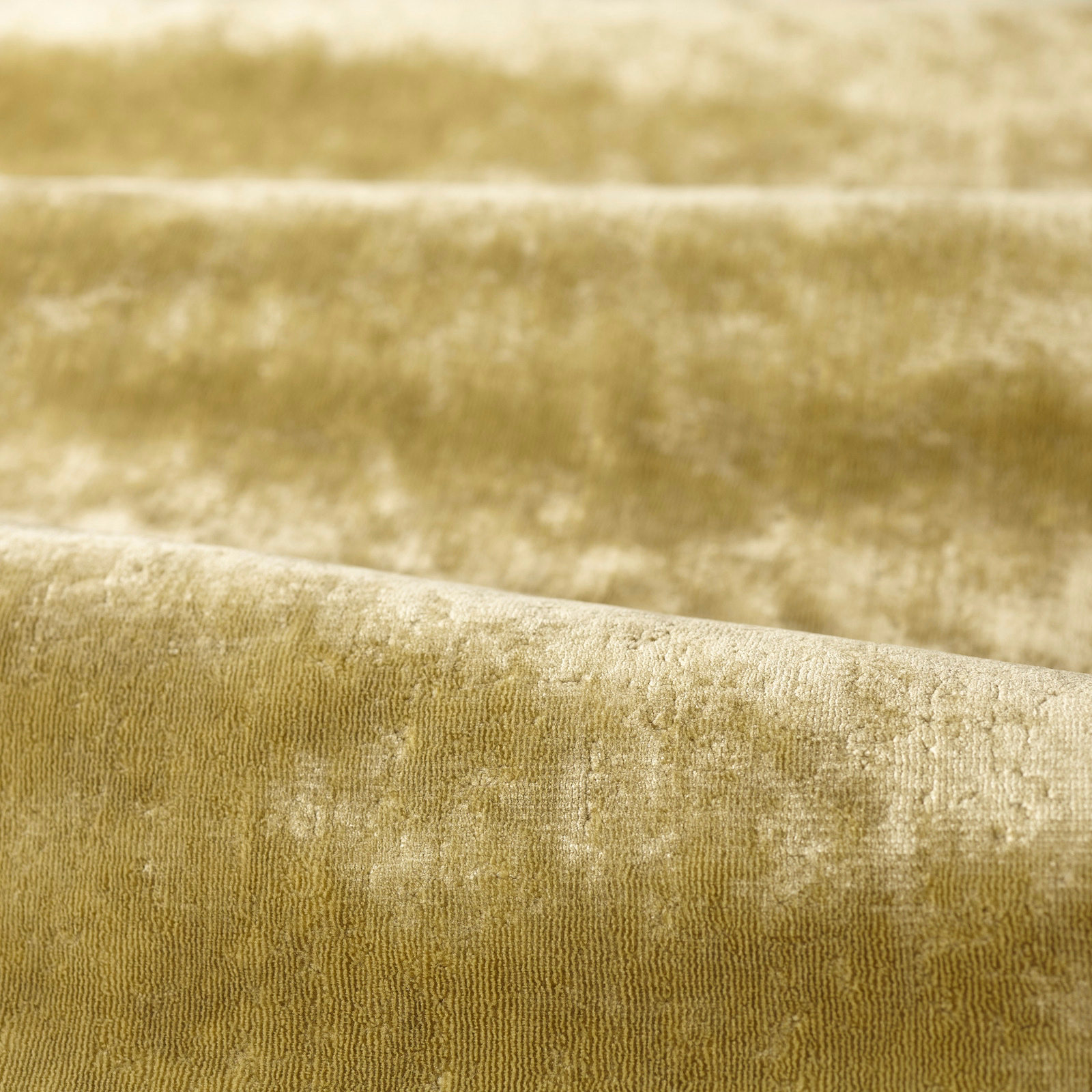 Muted green-tea olive textile with plush nap, pale-gold mottling and fine vertical ribbing