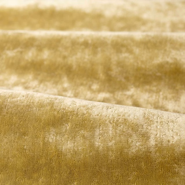 Muted green-tea olive textile with plush nap, pale-gold mottling and fine vertical ribbing