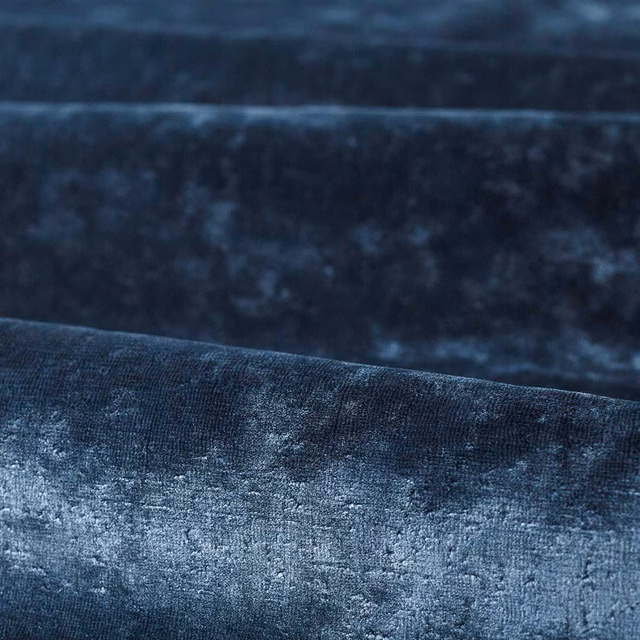 Deep indigo plain textile with smoky blue mottling and a soft lustrous texture