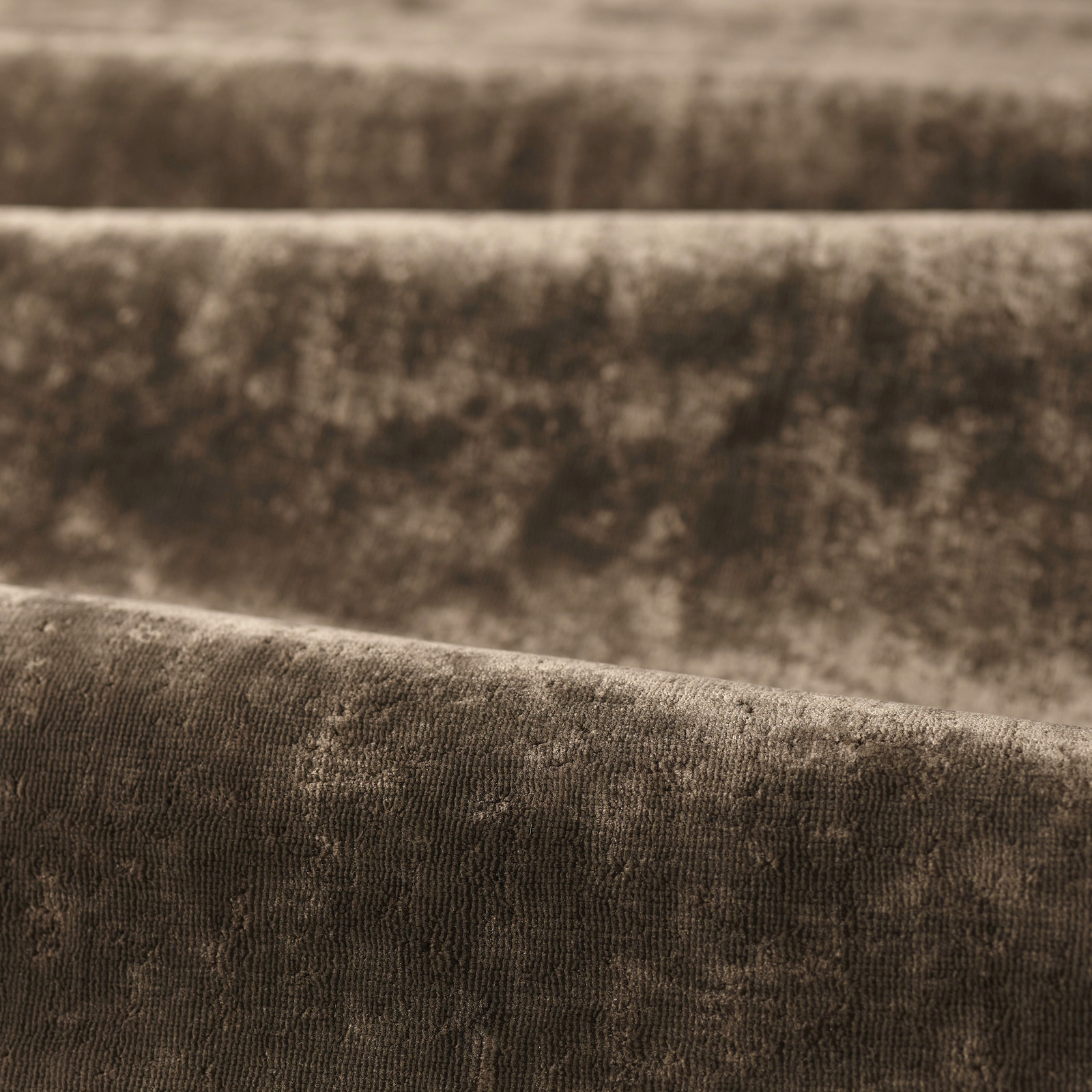 Close-up of deep mole taupe fabric with plush ribbed weave and mottled vertical shading