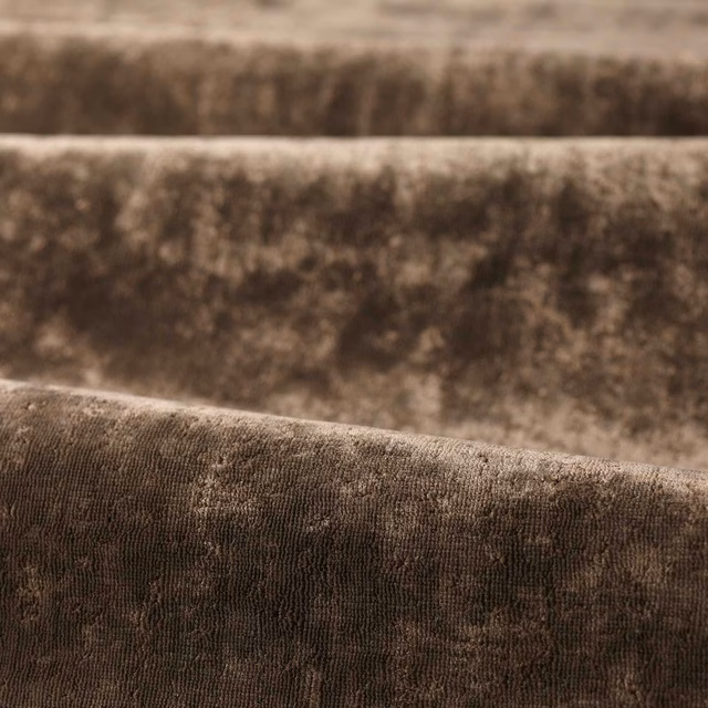 Close-up of deep mole taupe fabric with plush ribbed weave and mottled vertical shading