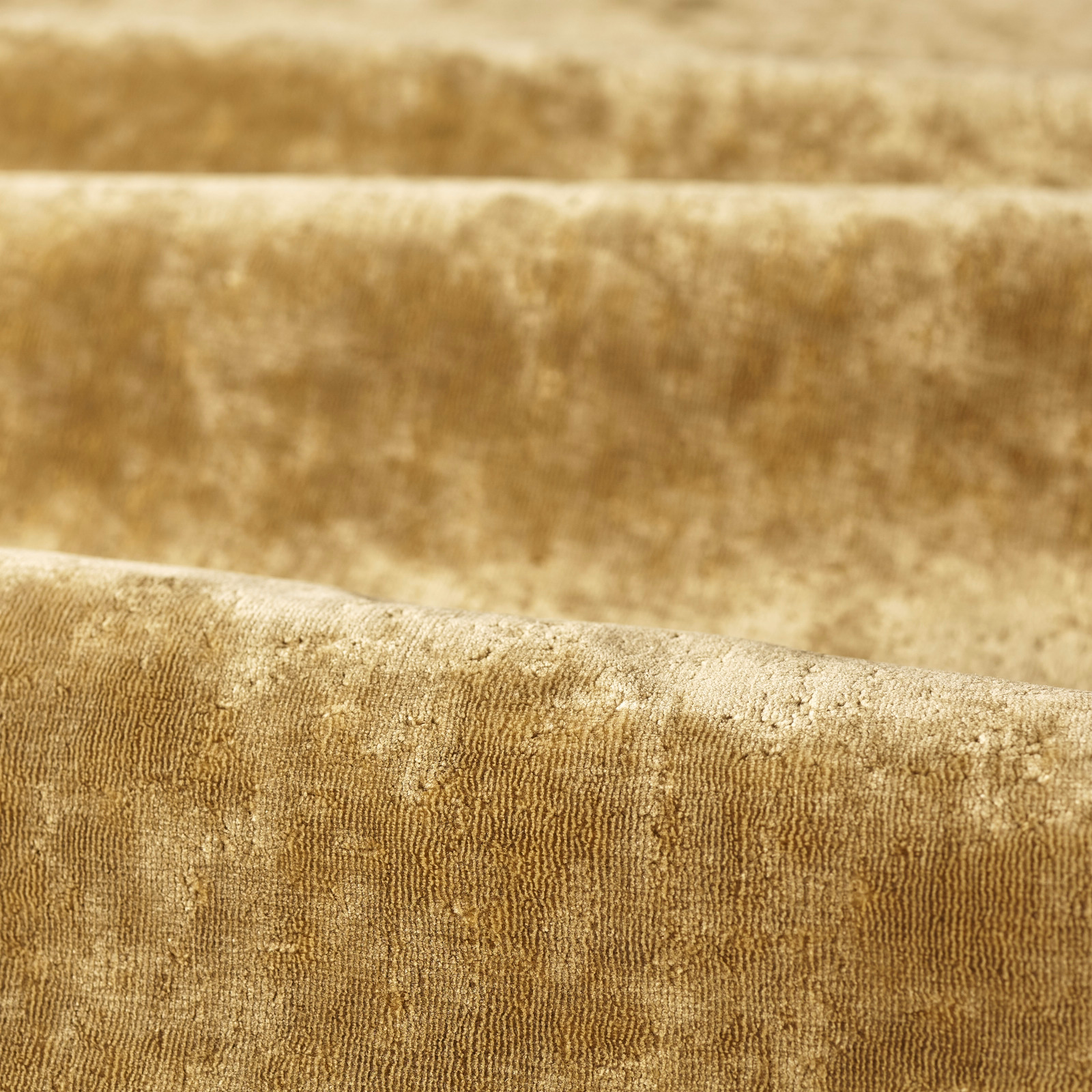 Plush old-gold fabric with mottled velvet pile and fine vertical rib texture