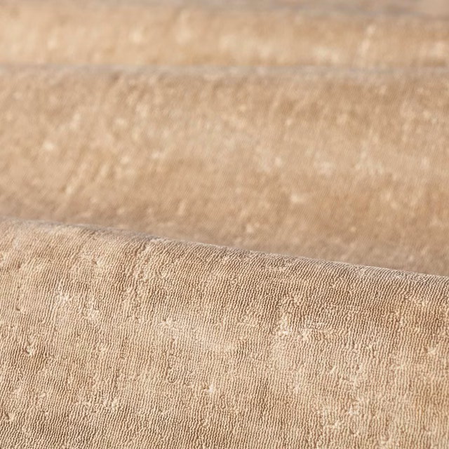 Warm pale beige upholstery weave with fine vertical ridges and raised flecks