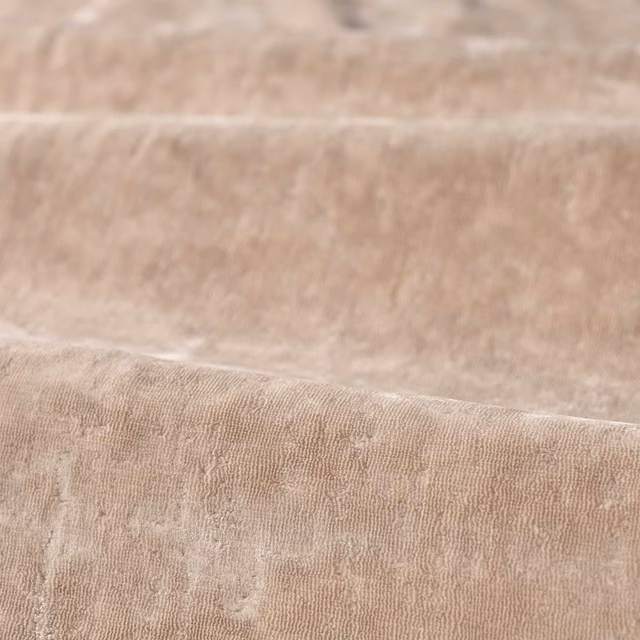 Blush-taupe plain fabric with fine rippled texture and soft directional sheen