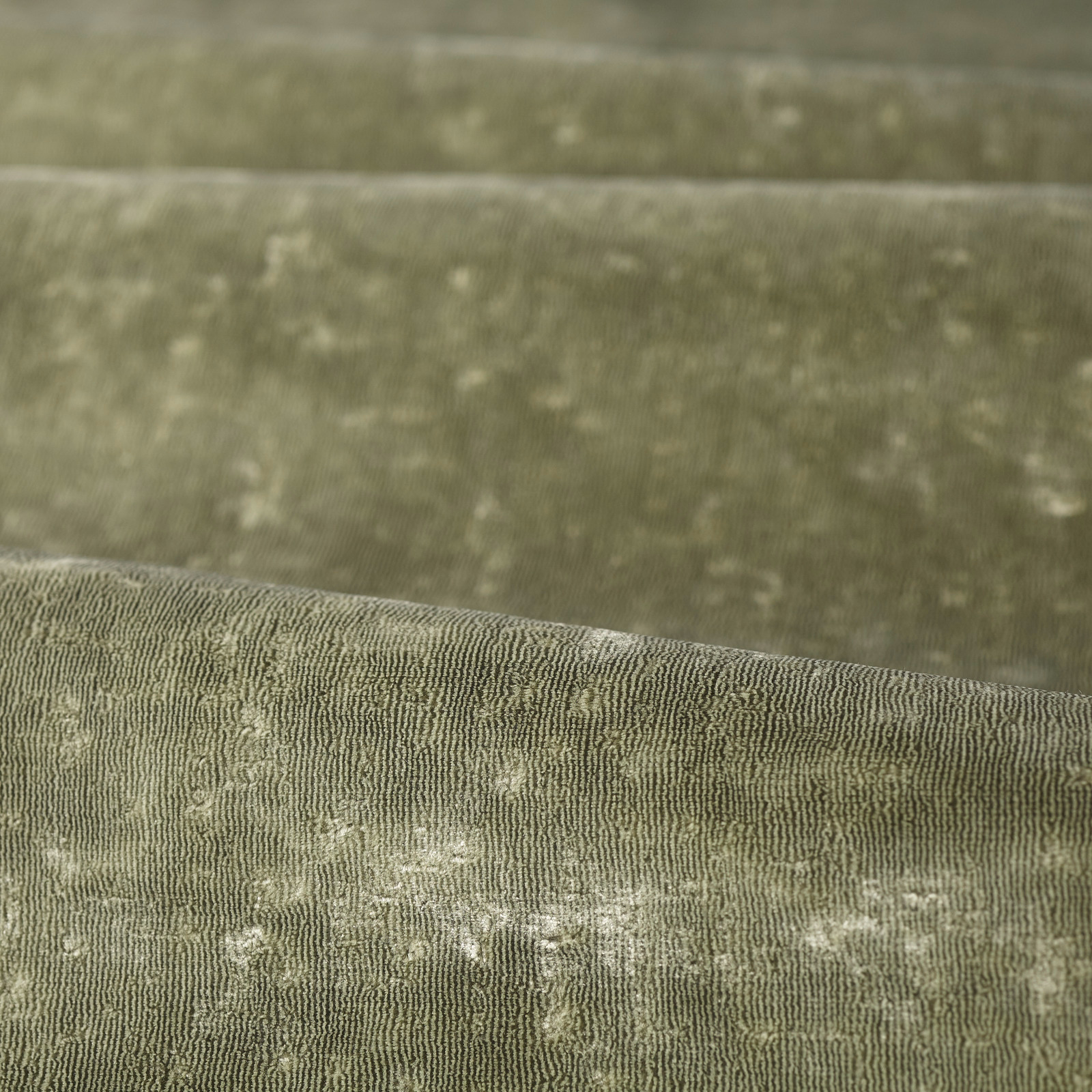 Muted sage-green woven swatch with fine vertical texture and pale cloudy flecks