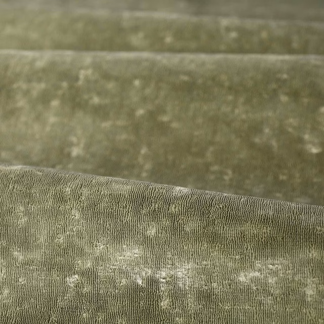 Muted sage-green woven swatch with fine vertical texture and pale cloudy flecks